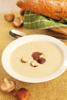 Mushroom soup by loaf of wholemeal bread
