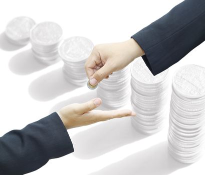 Businessman hand giving a coin for investment to another person on white background.
