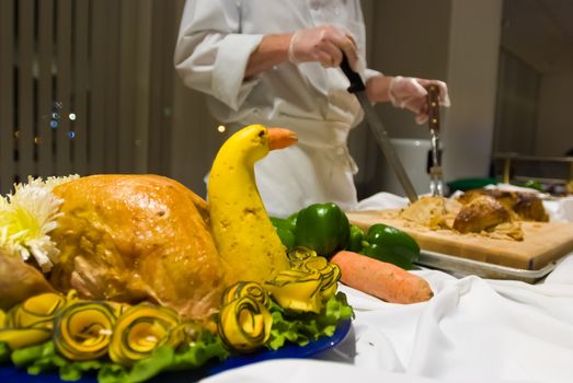 Server preparing to cut turkey at a buffet