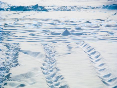 Footprints worn into the snow on a winter day