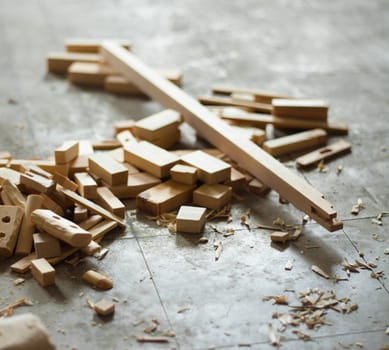 Cut wood pieces on the floor of a workshop