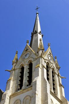 a church steeple with a clock on blue sky background