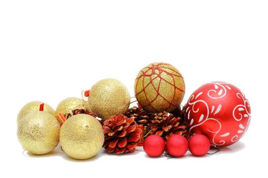 red and gold christmas baubles and pine cones isolated over white background