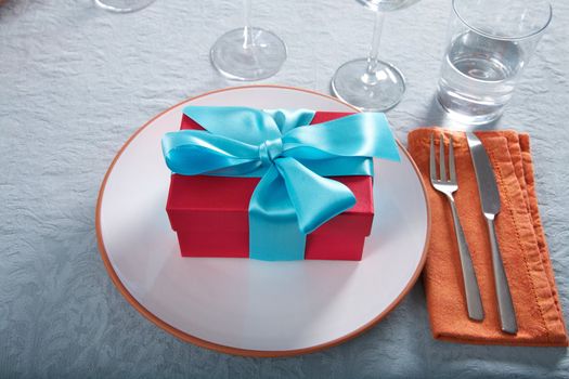 red gift box on white plate at restaurant