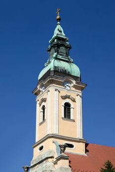 Church tower against blue sky