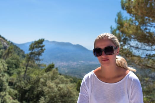 Girl with pony tail and sunglasses blonde in nature