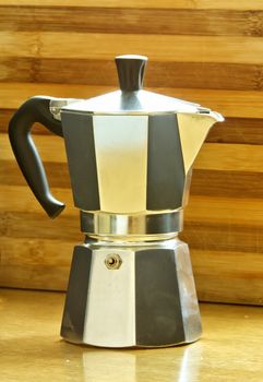 View of coffee pot with wooden background