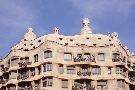 famous Barcelona landmark - Antonio Gaudi's work Casa Milo (or La Pedrera) building by bright sunny day