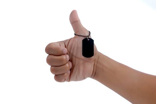 thumbs up and a black metal blank tag isolated on white background