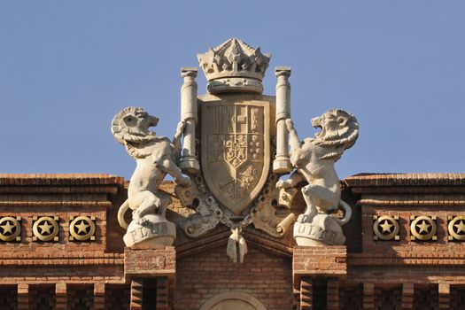 central top fragment of famous Arc de Triomf built for the 1888 Universal exhibition in Barcelona, Spain; Coat of Arms represents all Spanish provinces below a crown