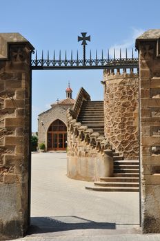 entrance gate with cross and medieval architecture background at one of the old Barcelona hospitals