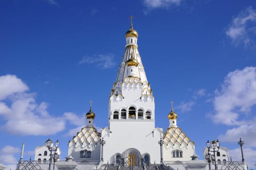 bright Orthodox Church under clear blue sky; All Saints orthodox Church in Minsk, Belarus