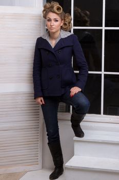 Beautiful full body young fashion model in coat posing