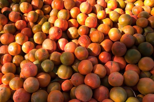 Background of orange tangerine fruits . Market.