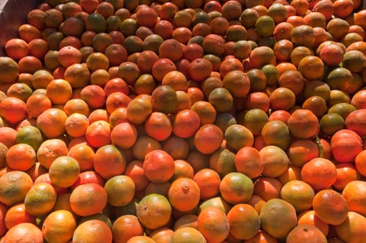 Background of orange tangerine fruits . Market.