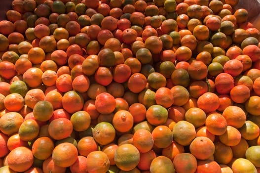 Background of orange tangerine fruits . Market.