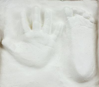 Little child's hand and foot print in gypsum