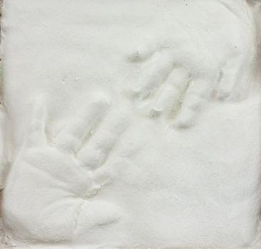 Toddler and baby hand prints in gypsum 