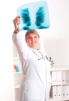 woman doctor looks at x-ray film, smile