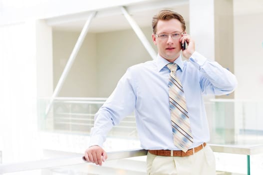 Smiling business man, talking on cell phone