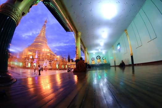 YANGON, MYANMAR - NOVEMBER 18: Buddhist devotees pray at the full moon festival, Shwedagon Pagoda, NOVEMBER 18, 2012 in Yangoon, Myanmar (Burma).