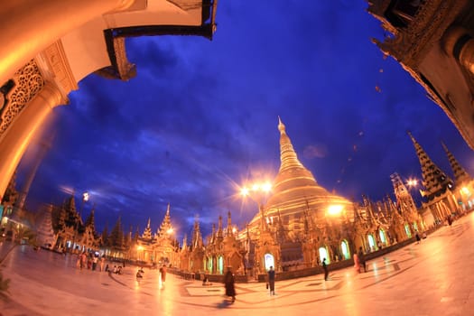 YANGON, MYANMAR - NOVEMBER 18: Buddhist devotees pray at the full moon festival, Shwedagon Pagoda, NOVEMBER 18, 2012 in Yangoon, Myanmar (Burma).