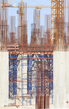 Construction site with enforced concrete steel frames rising up