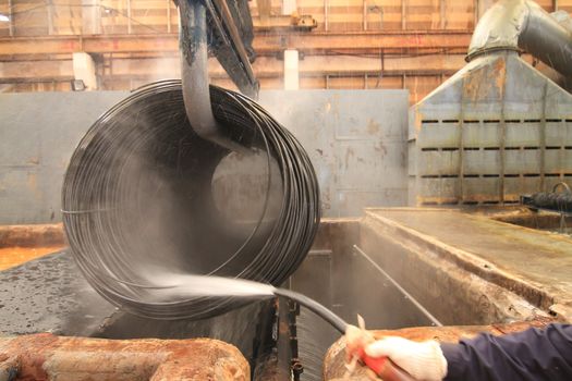 Large spools of Steel Coils being moved.