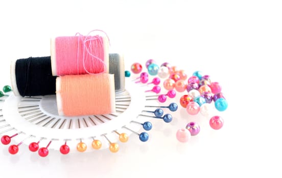 beads, pin, threads accessories on white background