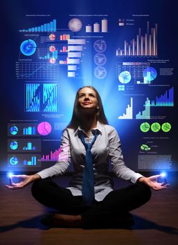 Businesswoman with financial symbols around her on the background