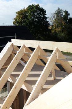 Construction site, wooden frame work, rooftop and beams Construction site, wooden frame work, roof top and beams