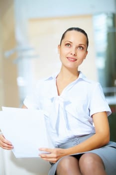 Portrait of happy smiling young businesswoman in office