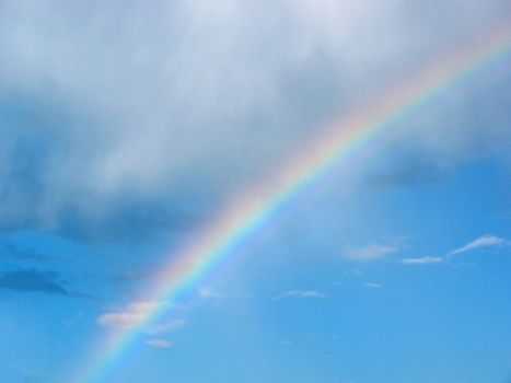 rainbow dividing clear and cloudy sky