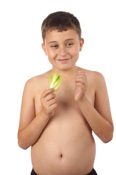 Boy eating a sprig of lettuce. Healthy diet concept