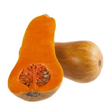 Cross section of a butternut squash with seeds and whole squash behind