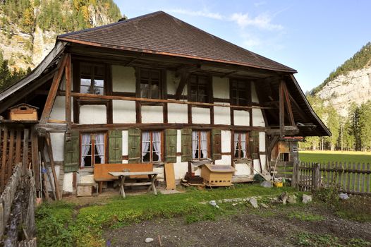 A Swiss farmhouse in the Gasteretal valley above Kandersteg, Switzerland. Space for text in the sky