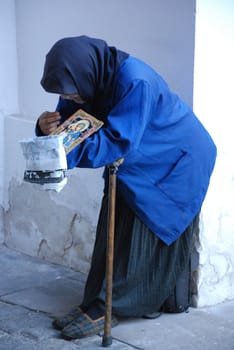 Begging woman near monastery entrance, Kazan, Russian Federation