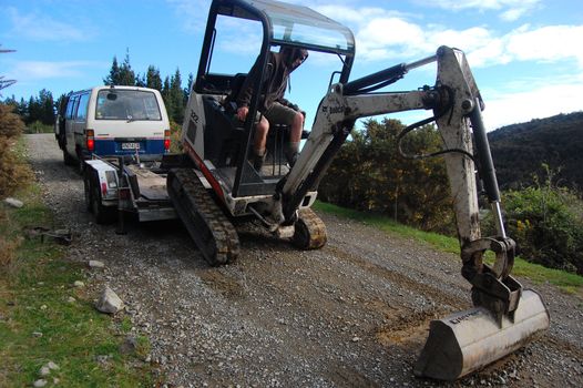 Man working on excavator, near Christchurch, New Zealand