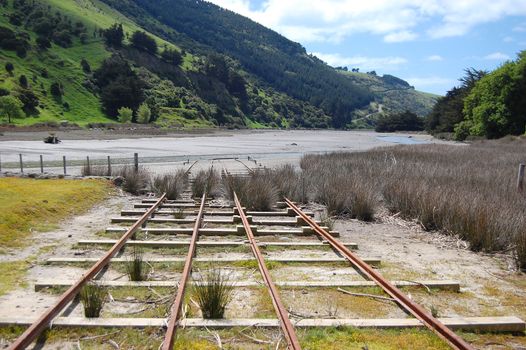 Old rails at riverside, Okains Bay, Banks Peninsula, New Zealand