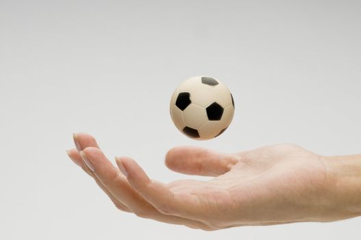 Soccer ball on female hand