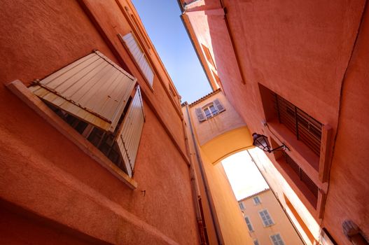 small narrow street with traditional window in Saint Tropez, France