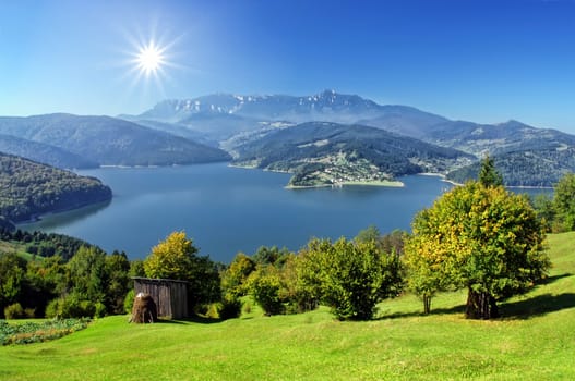 fresh autumn landscape with Carpathian mountain and lake, Romania 