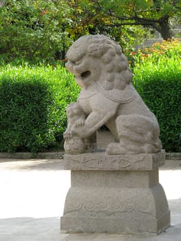 A granite lion in a garden in Santa Lucija, Malta.