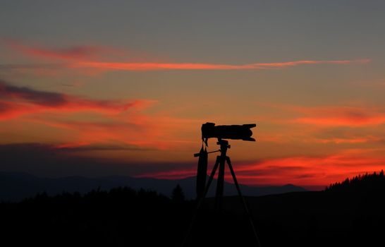 silhouette of a digital photo camera at sunset