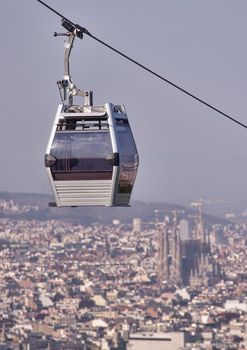 Teleferic of Montjuic, Barcelona with Sagrada Familia cathedral in blur background