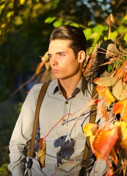 Attractive young male model in fall (autumn) outdoors in nature