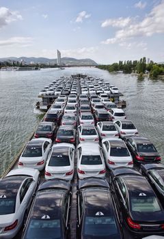 big boat carying a lot of cars on Danube river, Vienna