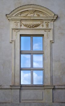 Antique, elegant window with reflection of blue sky