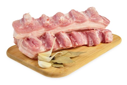 Raw bacon with ribs on a wooden cutting board. Isolated on white.