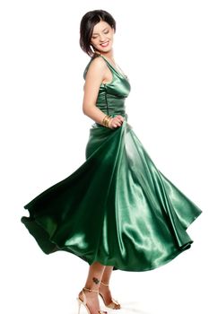 Youung brunette in a long green dress isolated on white